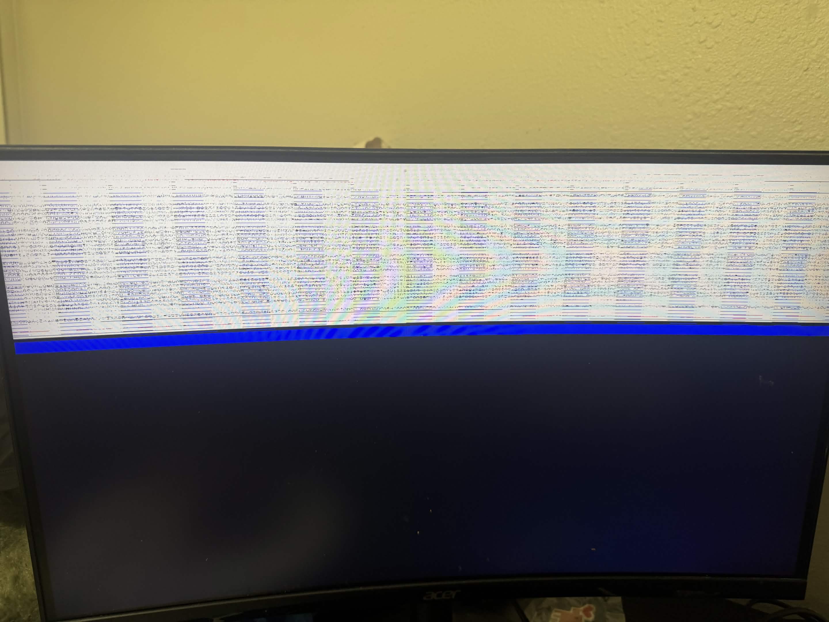 Monitor showing a band of corrupted static above a blank blue area